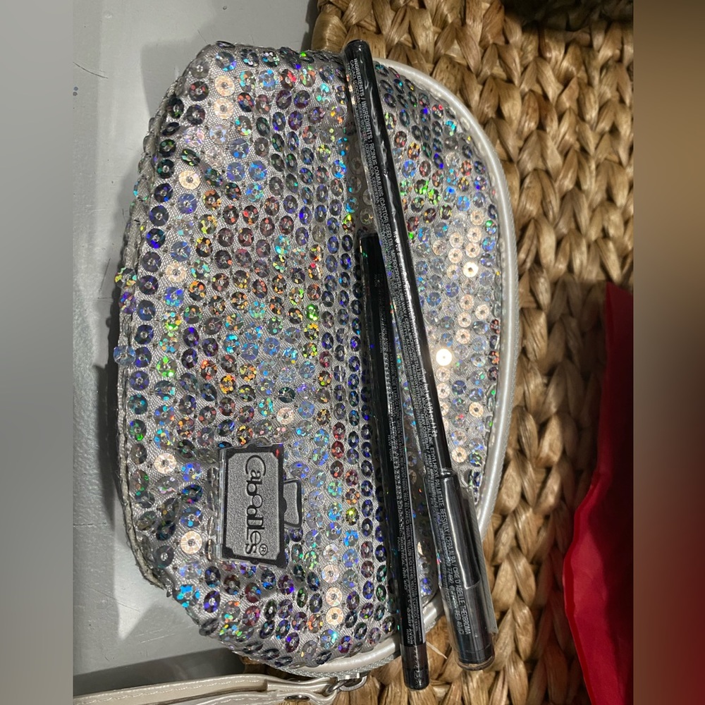 2 eyeliners and a Caboodles makeup bag.